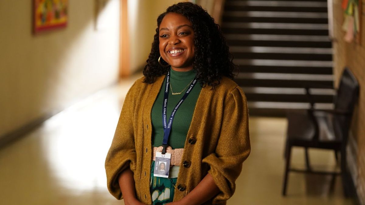 Janine smiling at the camera in the school hallway