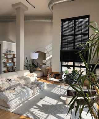 A small living room with white furniture and decor