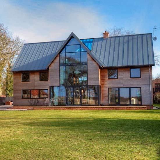 modern house with grass lawn and glass window