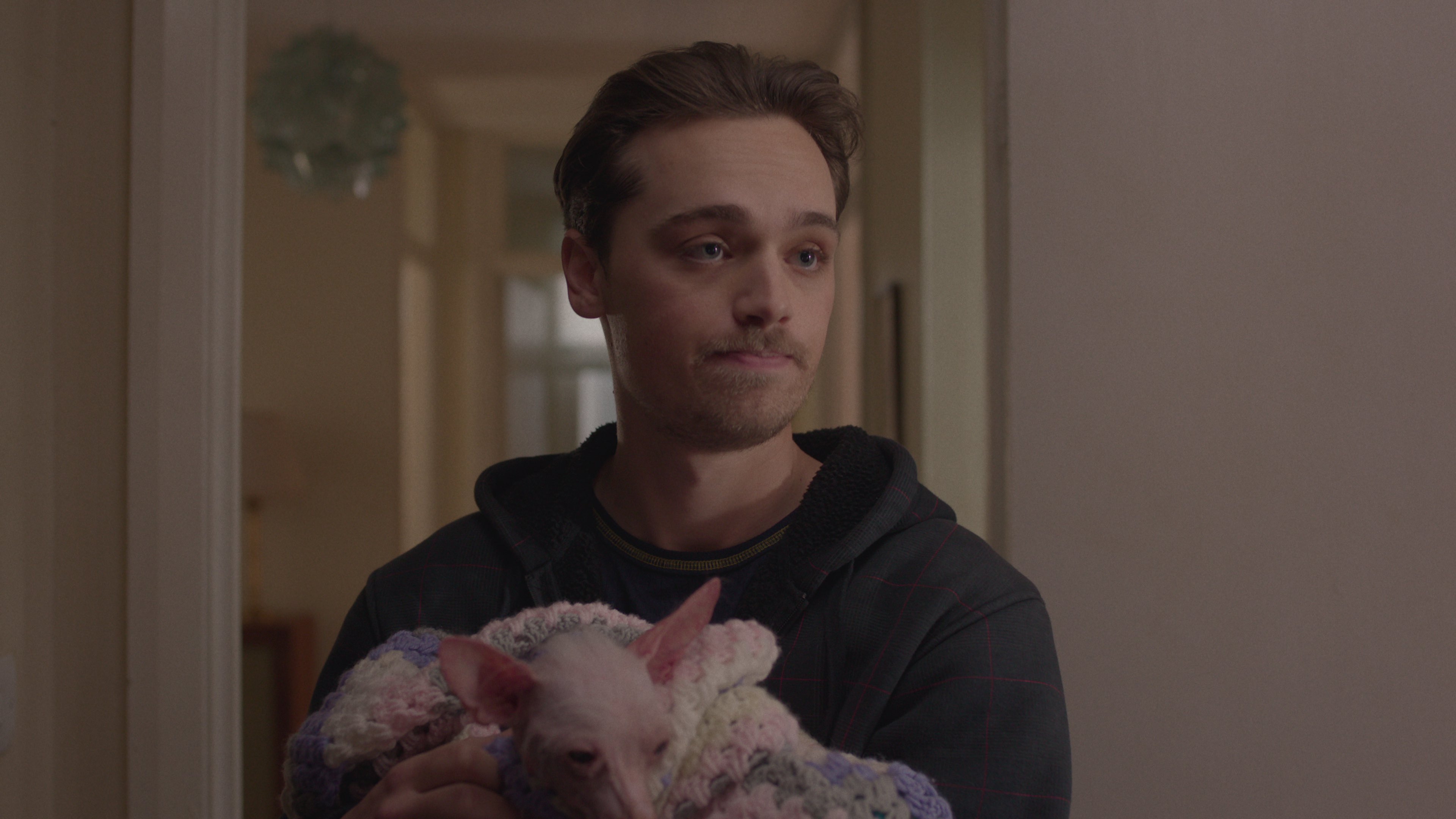 dean charles chapman as gaz holding the small dog named astrid in too much