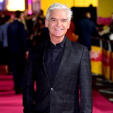 schofe with black blazer and red carpet