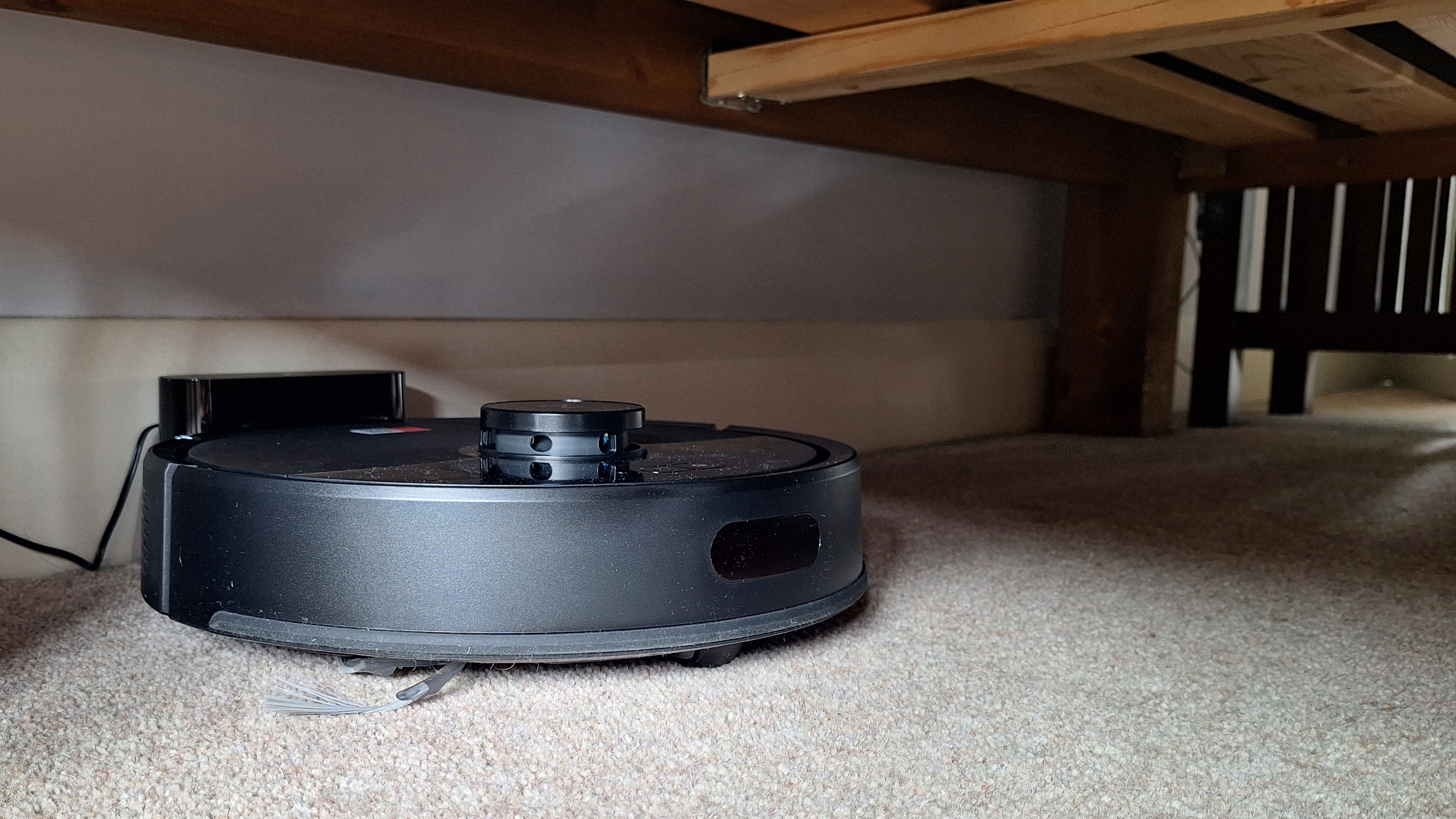 Roborock Q7 M5 robot vacuum under bed in tester's home