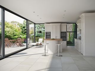 kitchen-diner with Valverdi floor tiles and sliding doors leading out to a paved terrace area