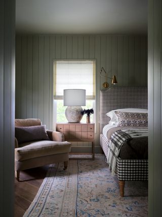 traditional style bedroom with olive green shiplap walls