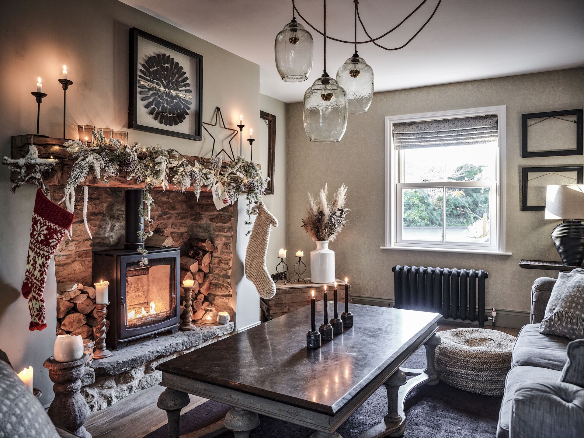 stone fireplace with stocking and Christmas decorations