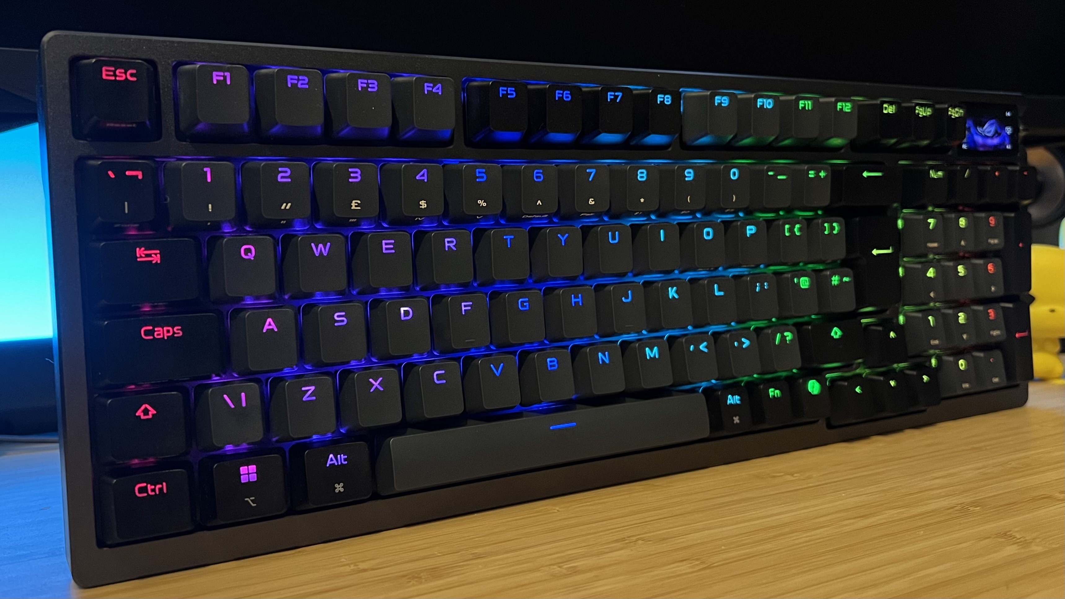 Asus ROG Azoth 96 HE gaming keyboard on a wooden desk