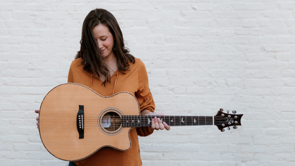 woman playing prs guitar