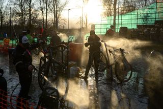 mechanics clean bikes in the pits at a cyclocross race