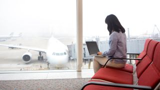 woman using laptop in airport