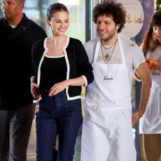 Selena gomez wears a black and white cardigan, matching tank top, denim capri pants, and pointed-toe patent-leather slingbacks.