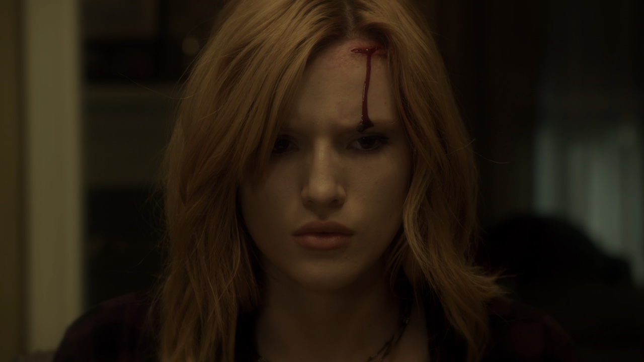 Bella Thorne with a stream of blood on her forehead in Amityville: The Awakening.