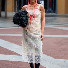 A guest in lace dress at Simone Rocha SS24 GettyImages-1687189606 Crop