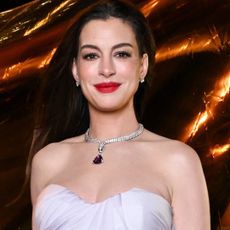 Anne Hathaway brought a little purple purse from Bulgari to a New York Fashion Week event