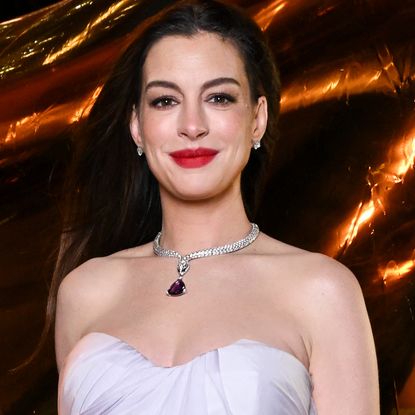 Anne Hathaway brought a little purple purse from Bulgari to a New York Fashion Week event