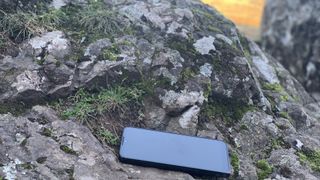 A phone lying on a rock