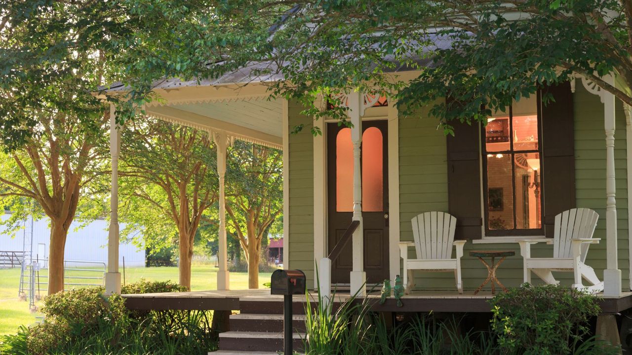 A front porch on a green painted house