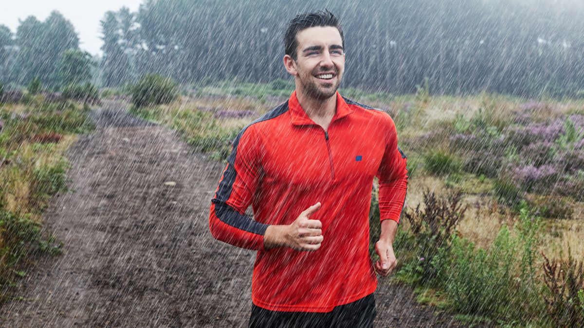 Happy man running in the rain