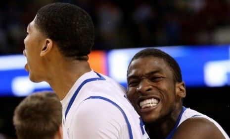 Michael Kidd-Gilchrist hugs Kentucky Wildcats teammate Anthony Davis 