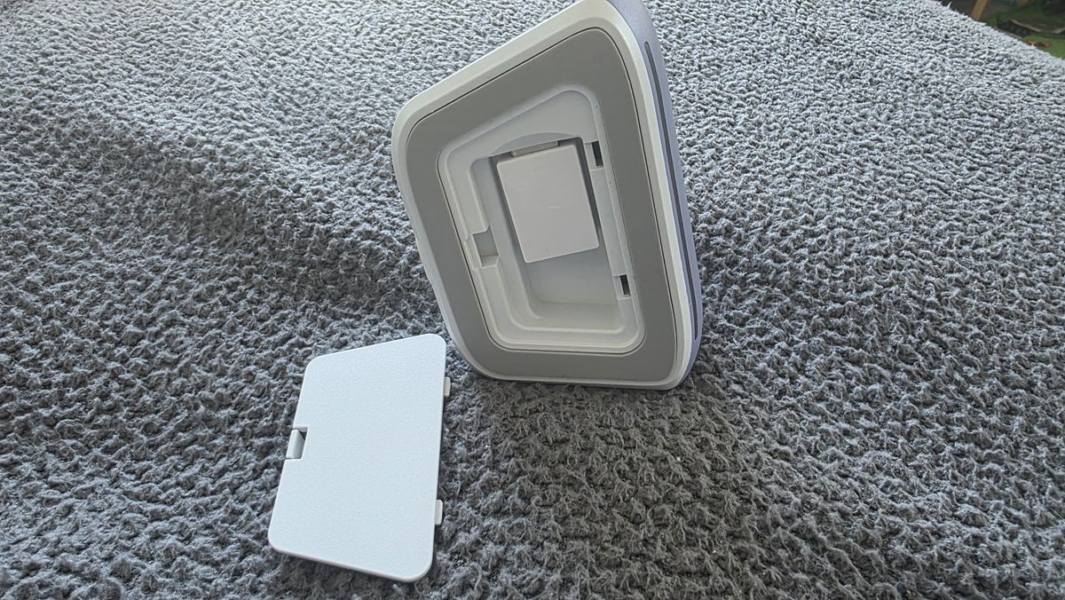 The charging dock for a GameSir controller with the rear open, revealing the dongle nestled inside