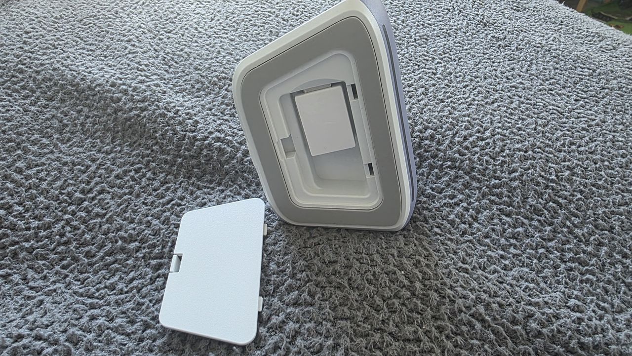 The charging dock for a GameSir controller with the rear open, revealing the dongle nestled inside