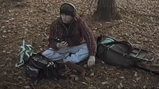 Michael Williams sitting in the leaves in The Blair Witch Project