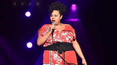 Desiree Burch on stage during stand-up show.