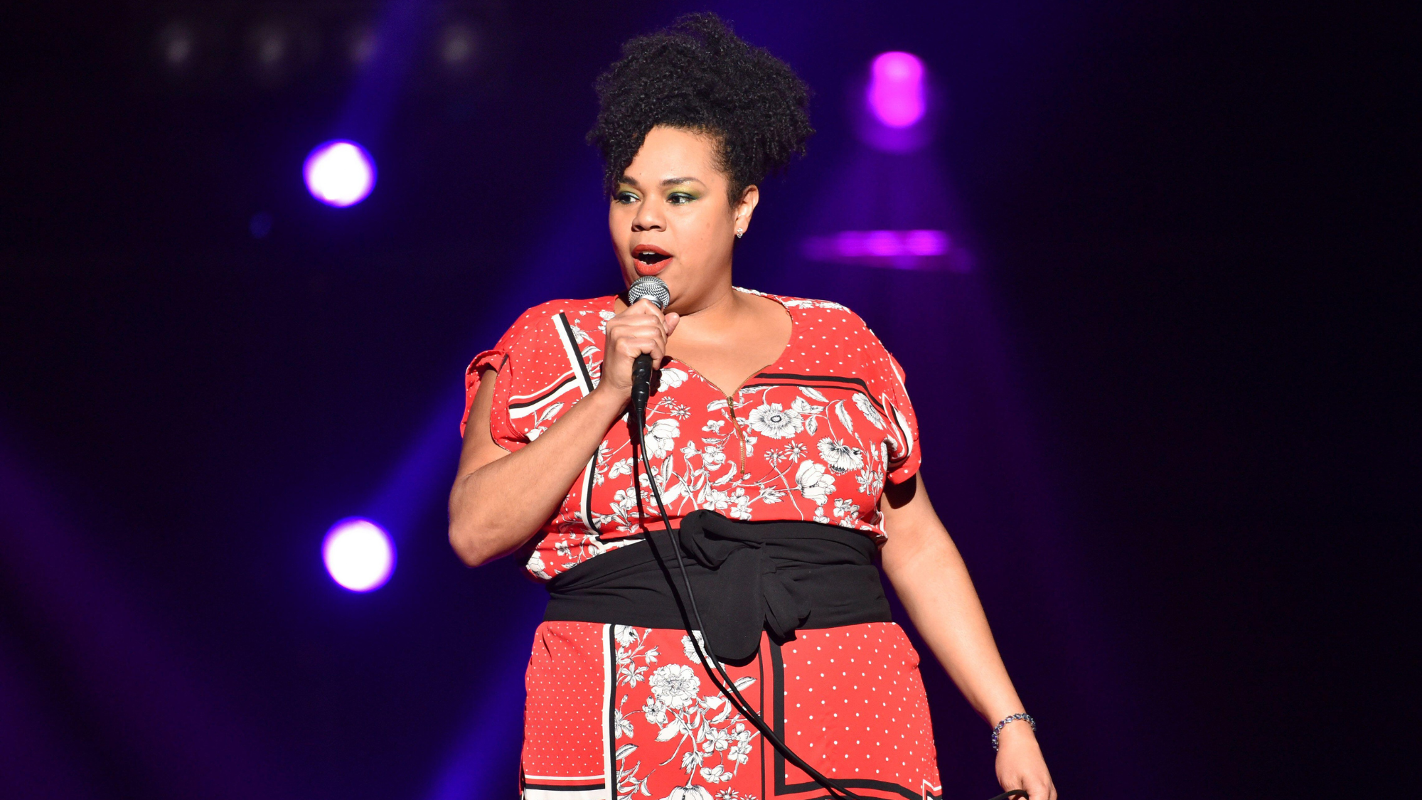 Desiree Burch on stage during stand-up show.