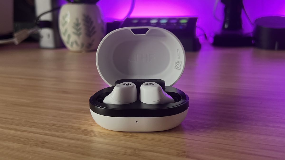 SteelSeries Arctis Game Buds in charging case on a wooden desk