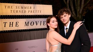 Jenny Han and Christopher Brinley pose in front of The Summer I Turned Pretty movie display