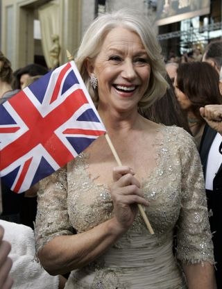 Helen Mirren waves a Union Jack flag on the red carpet at the 2007 Oscars