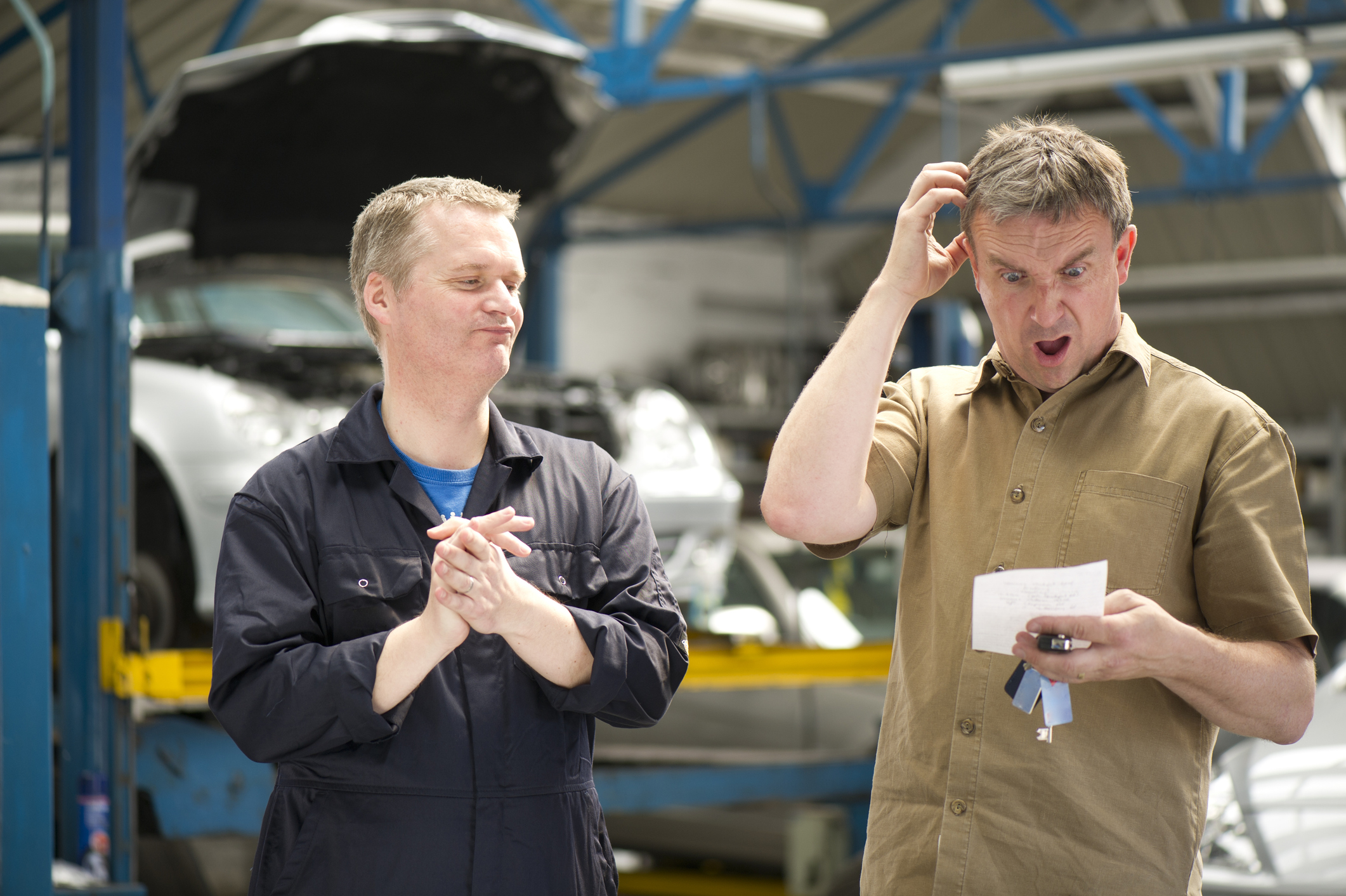 a man receiving a surprise auto repair bill