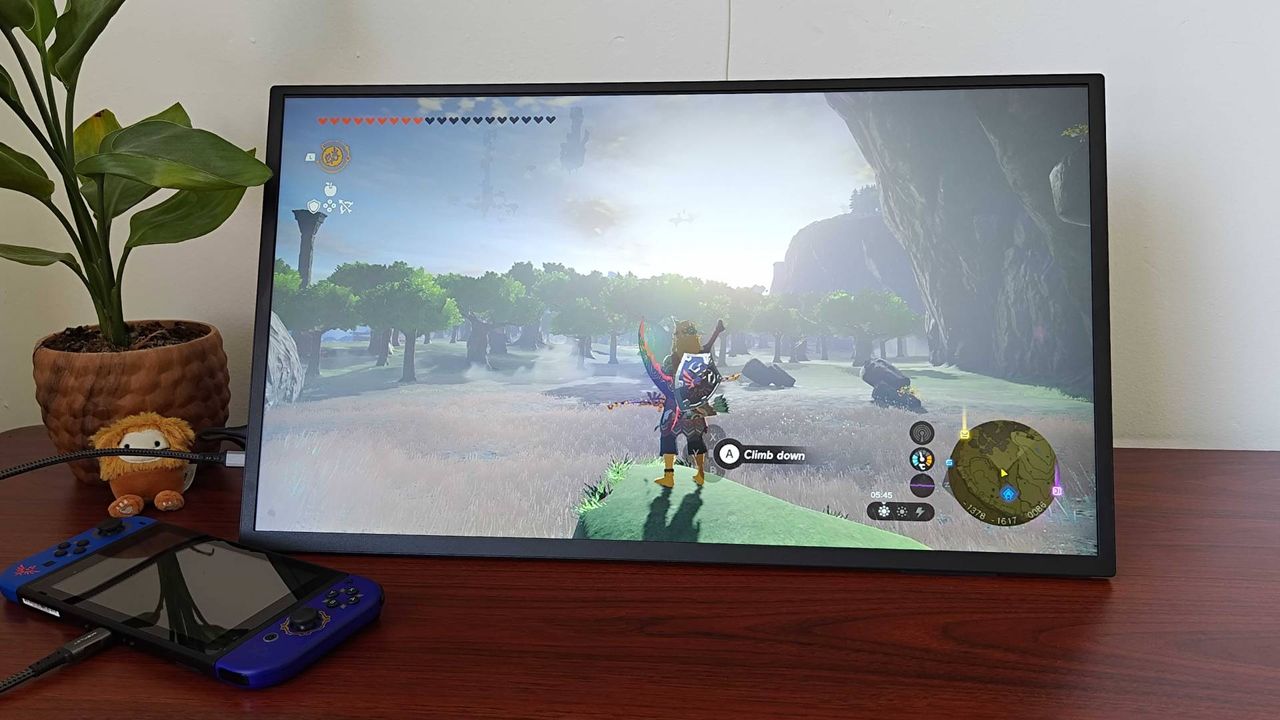 Uperfect Umax 24 portable monitor with Zelda: Tears of the Kingdom gameplay opn screen featuring Link standing on rock looking into distance.