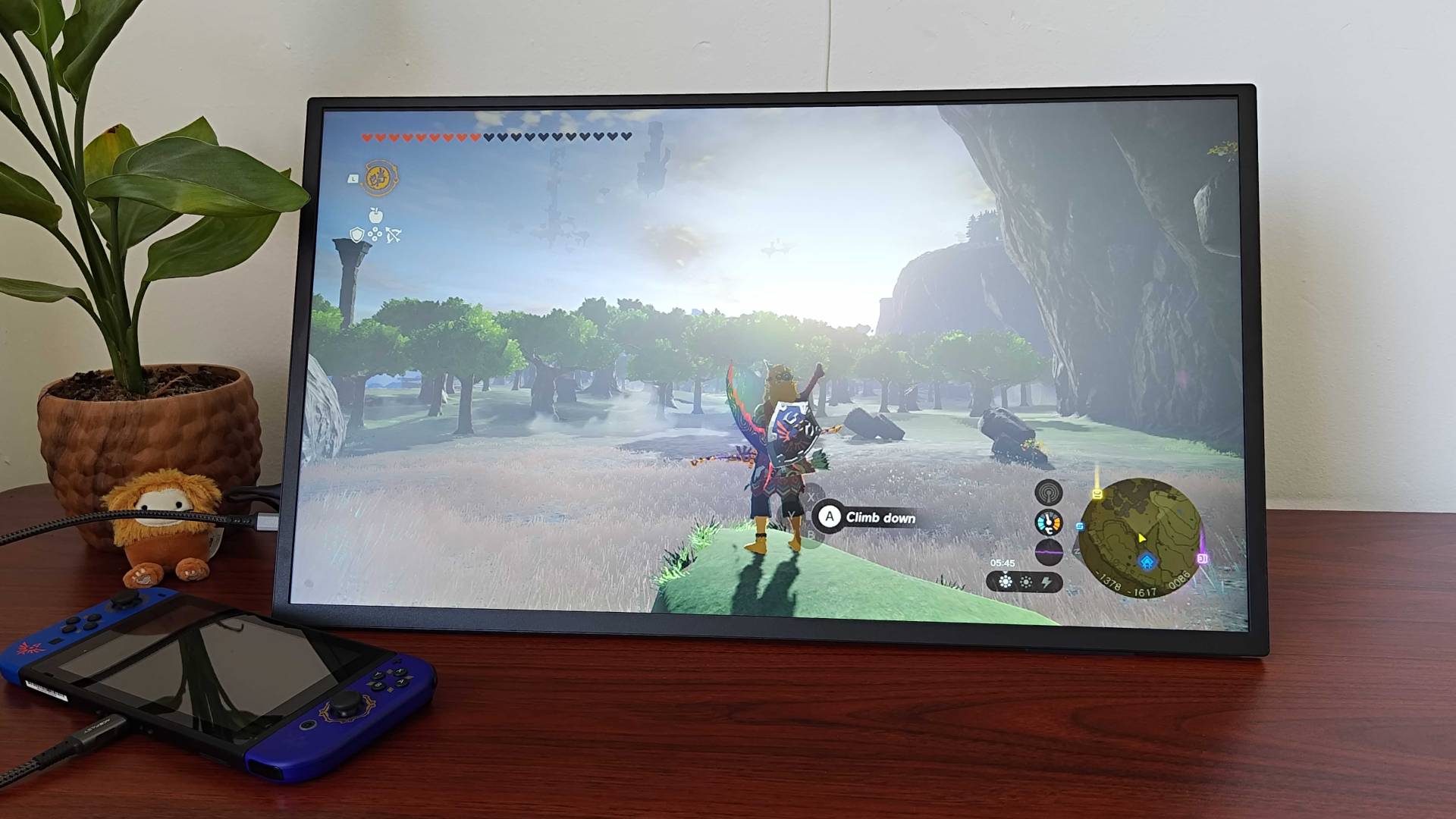 Uperfect Umax 24 portable monitor with Zelda: Tears of the Kingdom gameplay opn screen featuring Link standing on rock looking into distance.