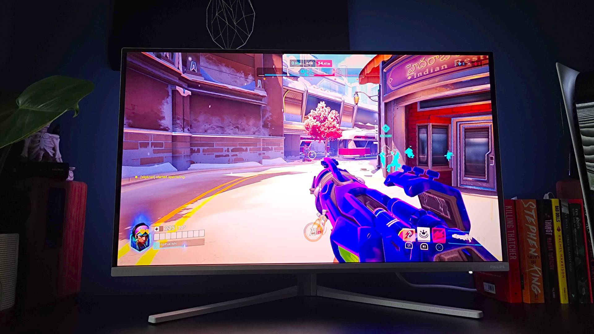 Philips Evnia 32M2N8900 monitor with Overwatch gameplay on screen.