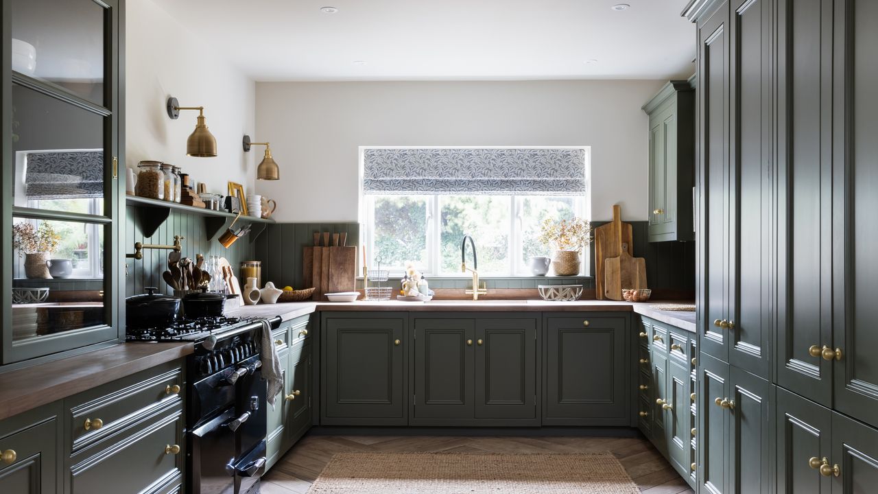 Grey kitchen cabinets with wooden floor and white window