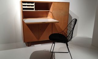 White wall and floor, wood desk unit, black mesh back design desk chair