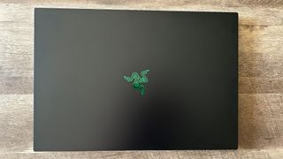 Razer Blade 18 gaming laptop with lid closed on a wood table