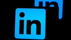 The LinkedIn logo (the letters "LI" on a blue square) with its reflection behind it against a dark background.