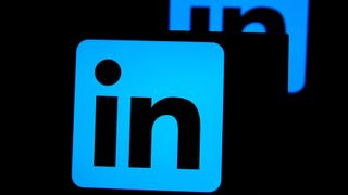 The LinkedIn logo (the letters "LI" on a blue square) with its reflection behind it against a dark background.