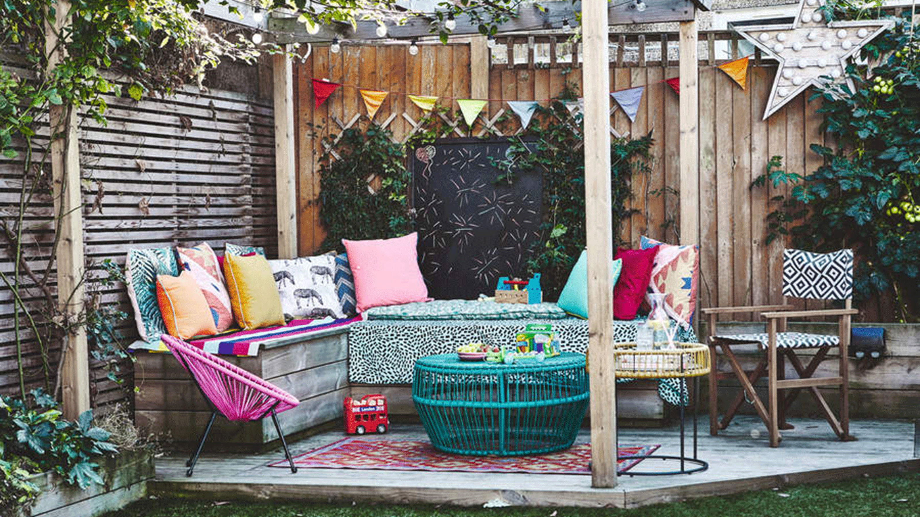 A kids activity area on a deck with chalkboard, bunting and colorful accessories