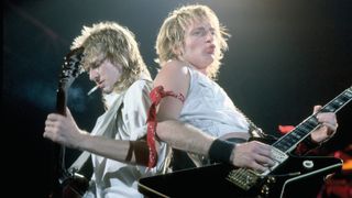Steve Clark (left) and Phil Collen perform with Def Leppard in 1983.