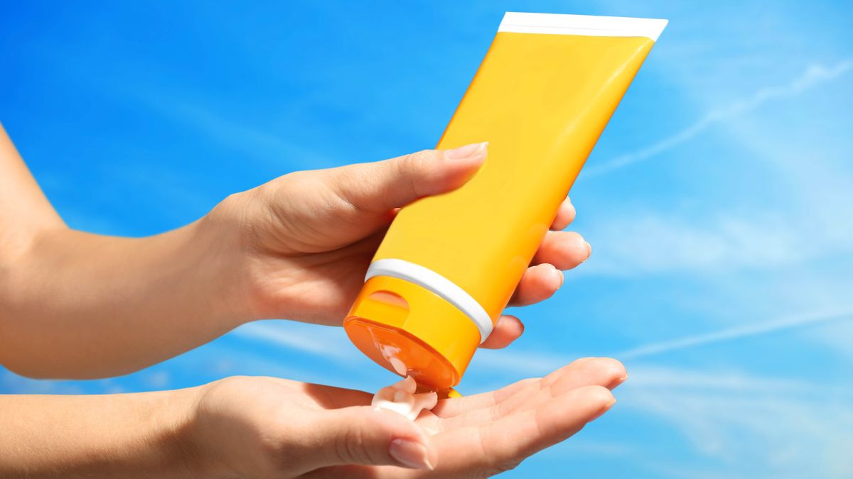 Sunscreen being squeezed into a hand