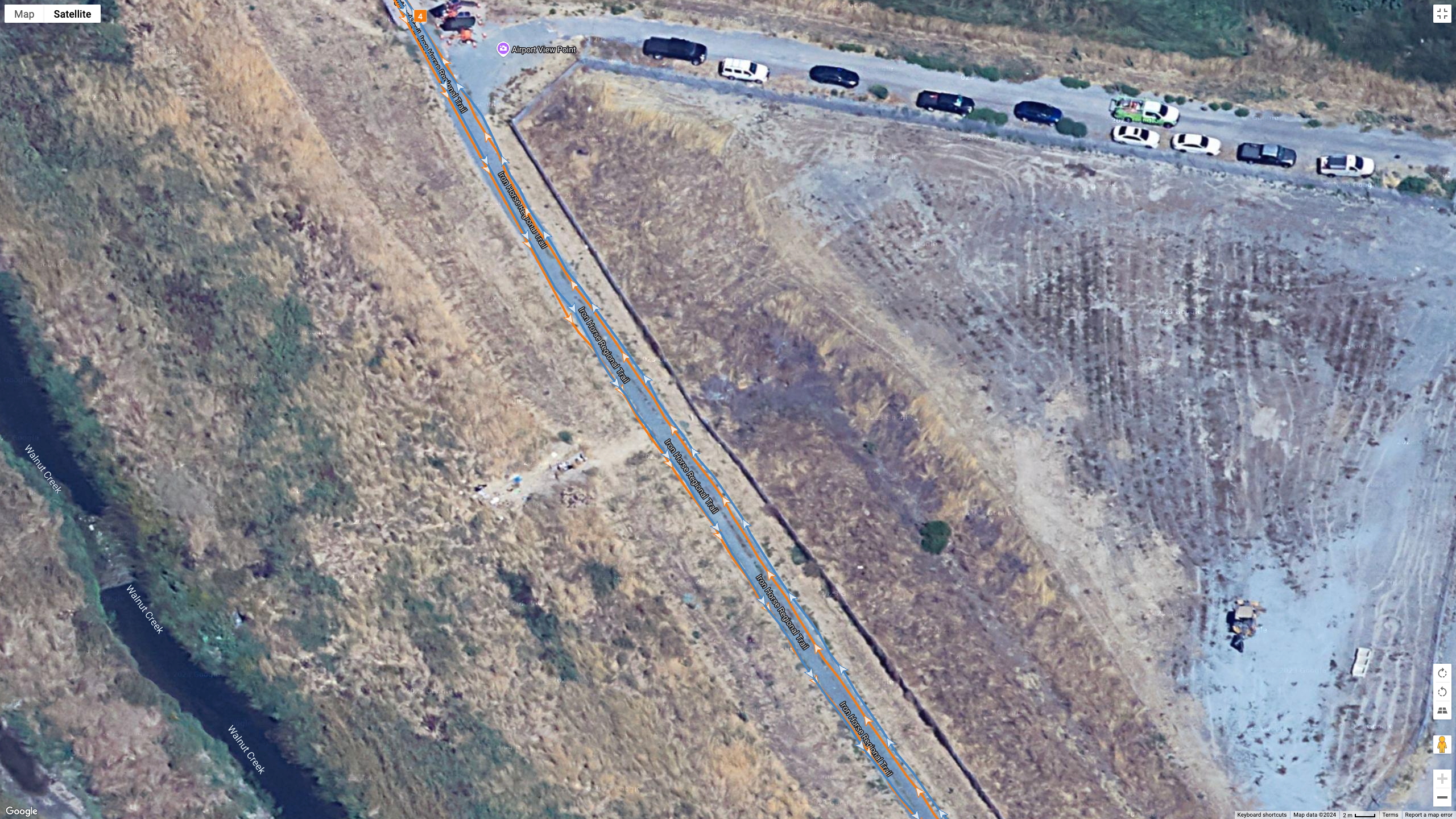 A Google Maps satellite view showing how the Polar Vantage M3 (orange line) and Garmin Fenix 8 (blue line) compared for GPS accuracy during a run.