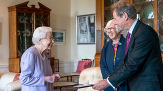 EDINBURGH, SCOTLAND - JUNE 28: Queen Elizabeth II presents Her Majesty's Medal for Music for the year 2021 to John Wallace CBE at the Palace of Holyroodhouse, Edinburgh on June 28, 2022. Mr Wallace was presented by Judith Weir, Master of the Queen's Music. Members of the Royal Family are spending a Royal Week in Scotland, carrying out a number of engagements between Monday June 27 and Friday July 01, 2022.