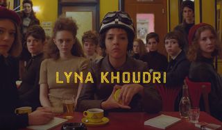 The French Dispatch Lyna Khoudri shuffles cards at a cafe