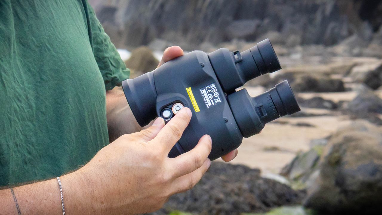 A close up of the battery compartment on the Canon 12x36 IS III binoculars.