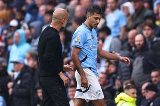 MANCHESTER, ENGLAND - SEPTEMBER 22: Rodri of Manchester City and Pep Guardiola manager of Manchester City as he goes off injured during the Premier League match between Manchester City FC and Arsenal FC at Etihad Stadium on September 22, 2024 in Manchester, England. (Photo by Robbie Jay Barratt - AMA/Getty Images)