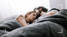 Couple lying in bed together asleep, close and intimate, representing an end to the spooning sex position