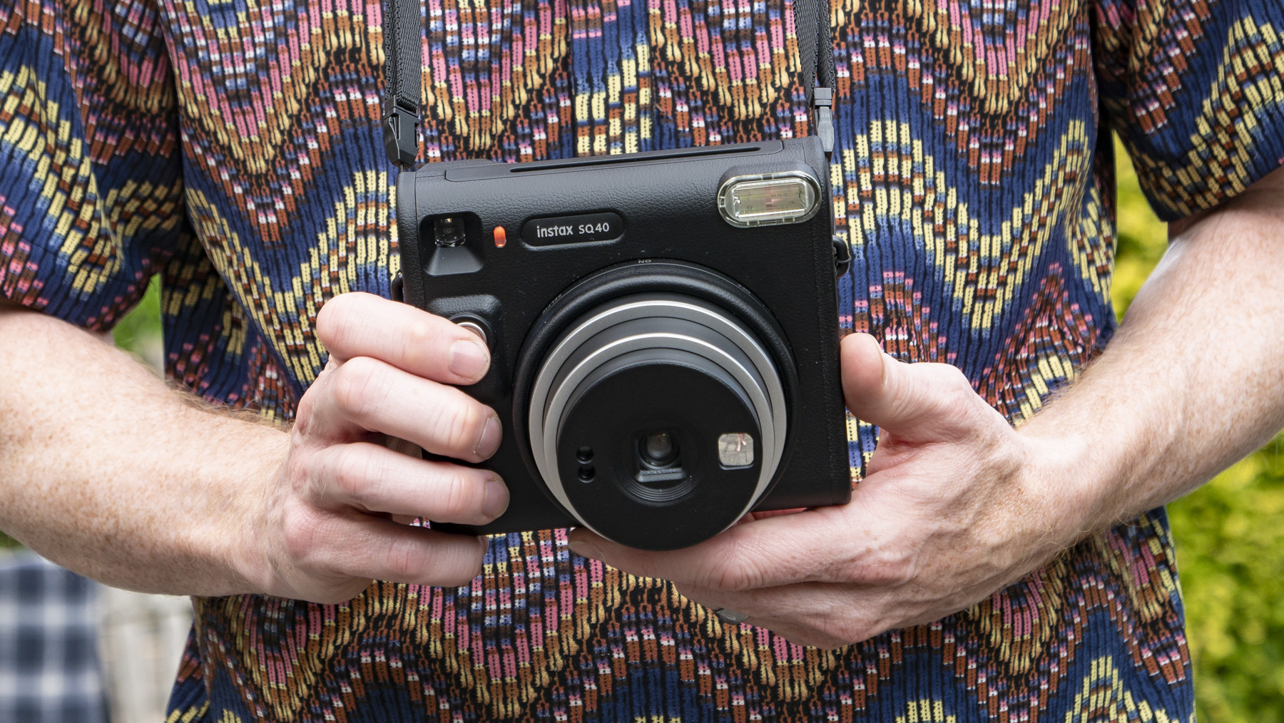 Fujifilm Instax SQ40 camera in reviewer's hands