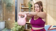 Woman exercising with kettlebell at home